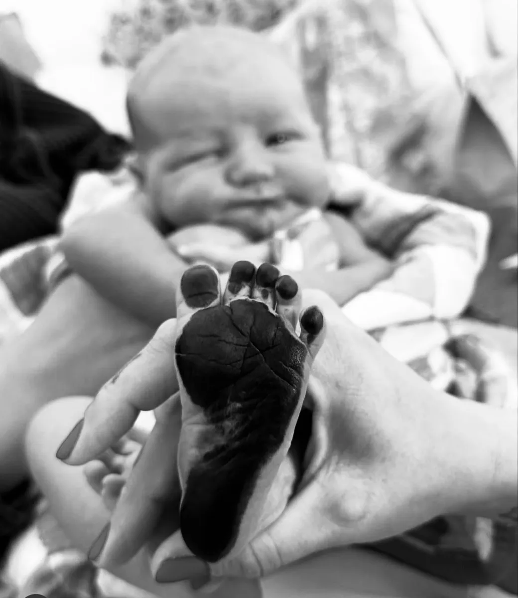 Midwives supporting a mother through a water birth