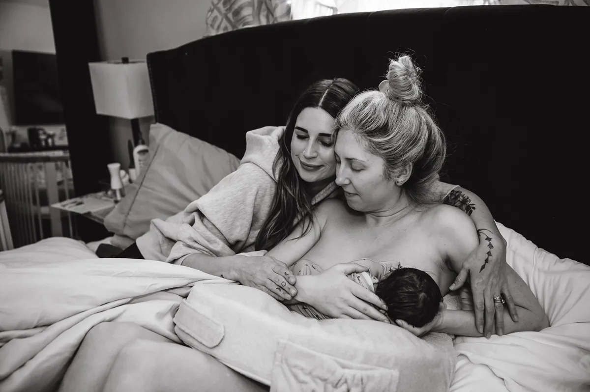 A newborn checked over closely, held skin-to-skin between mom and dad